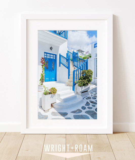 mykonos, greece. featuring blue and white building on grey cobblestone street