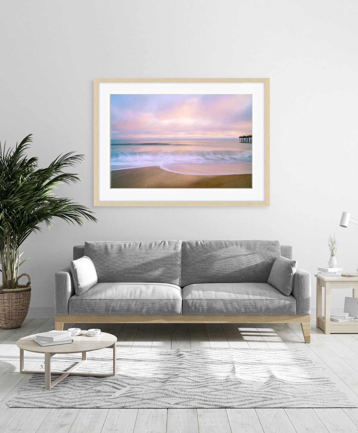 modern living room featuring large framed beach sunrise photograph