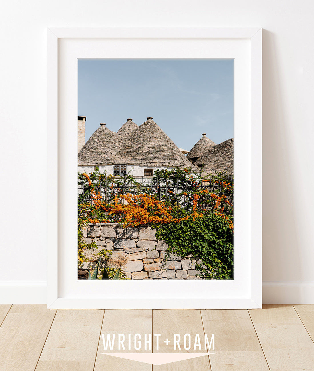 italy wall art in white frame. Photograph features the trulli houses in Alberobello