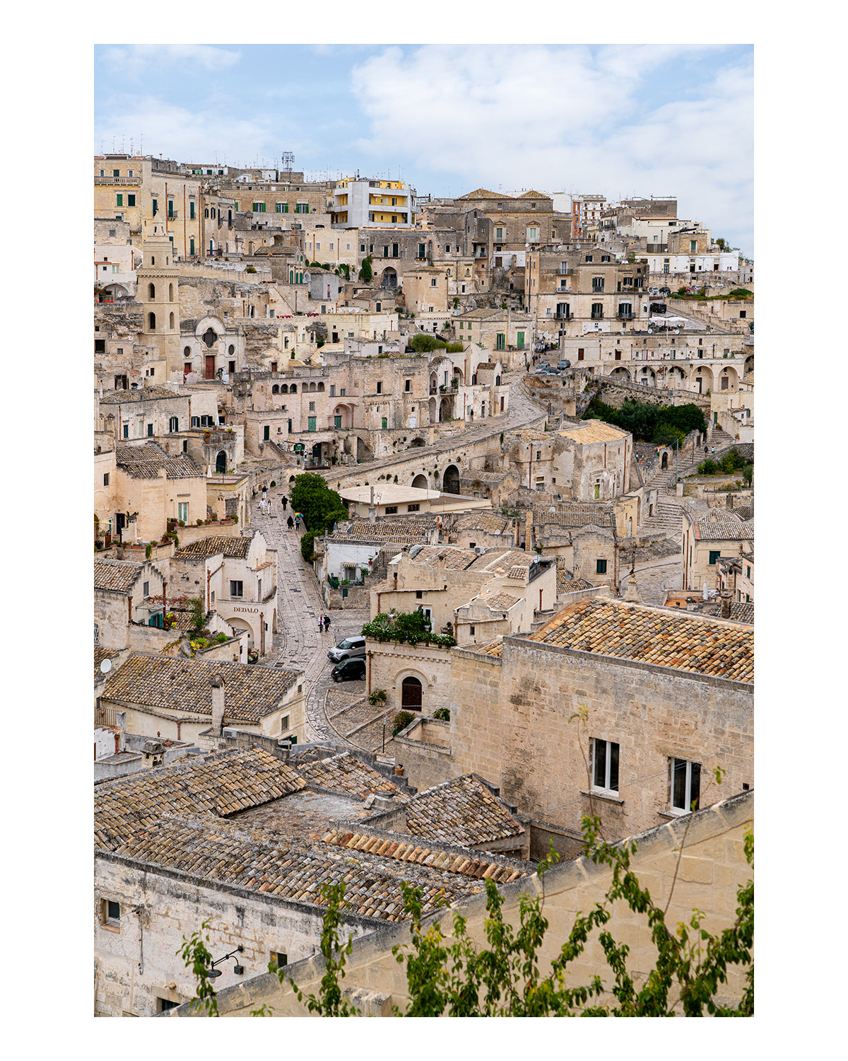 unframed photograph of Matera Italy with stone buildings and blue sky