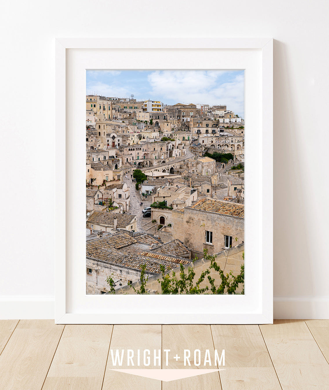 Historic stone buildings and textured streets in Matera, Italy with soft blue sky in a vertical architectural photograph.