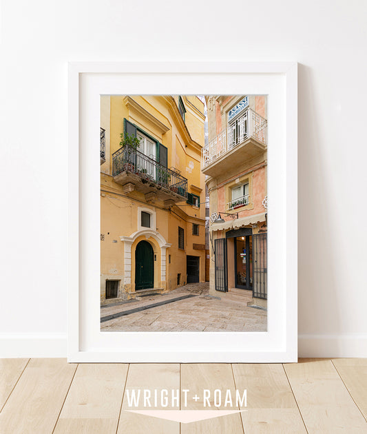 Fine at Italy photograph in White frame featuring yellow and pink historic buildings in Italy featuring aged plaster texture and Mediterranean architectural detail.