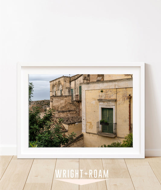 Souther Italy photograph feautring historic architecture, textured stone and plaster in muted yellow and green tones.