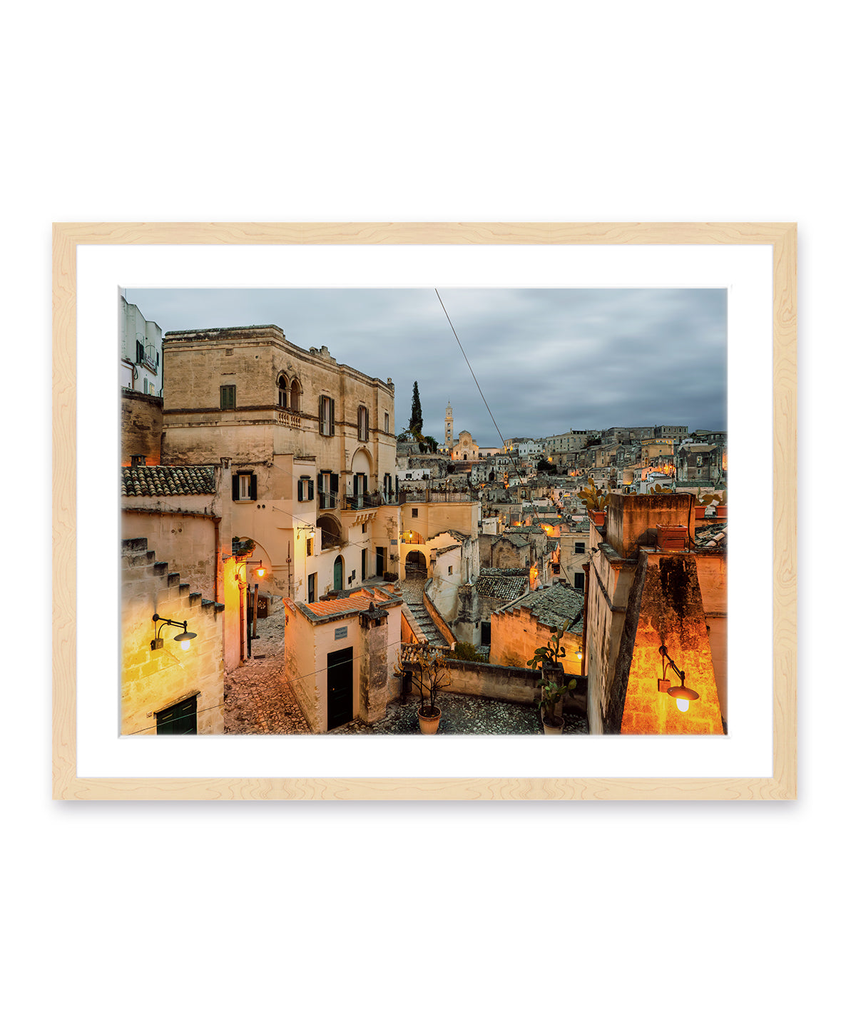 Framed Matera Italy twilight architecture photograph showcasing historic city streets and golden streetlights in light wood frame