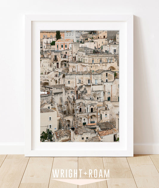 Matera Italy Photograph in white frame leaning against a white wall and wood floors.
