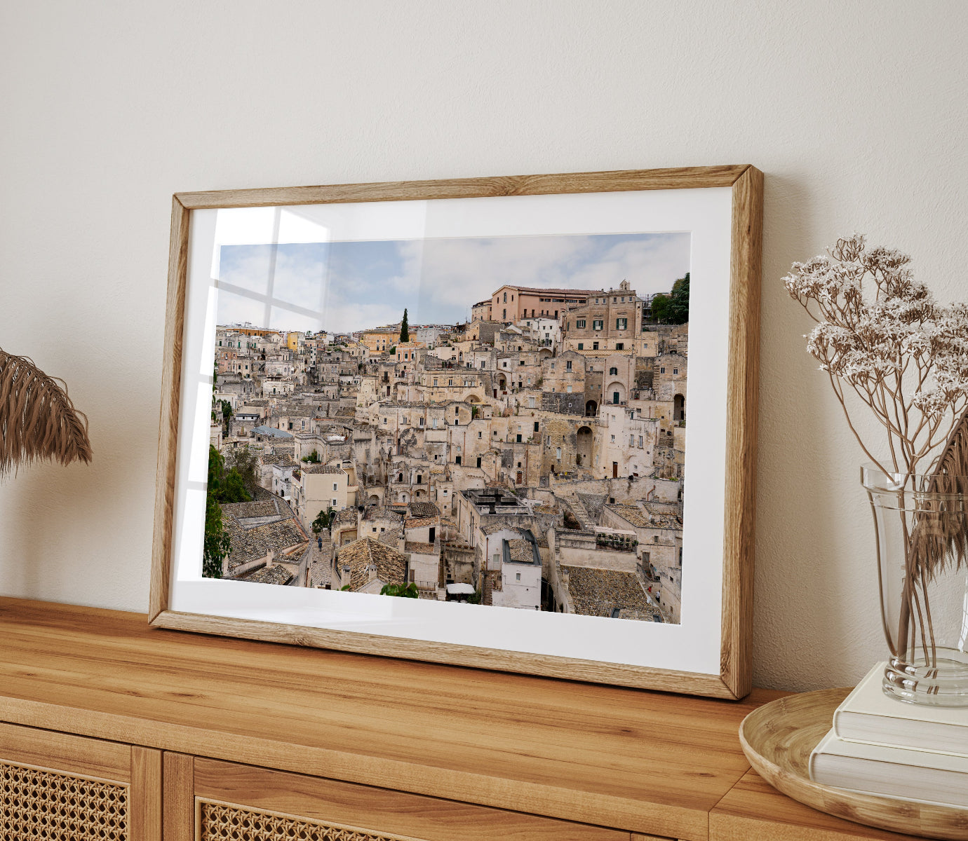 Horizontal photograph of Matera, Italy architecture featuring layered stone buildings and textured streets.