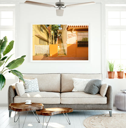 surf shak decor featuring large framed travel photography of orange buildings in rincon puerto rico