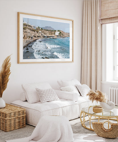 boho coastal living room decor with large framed greece beach photograph