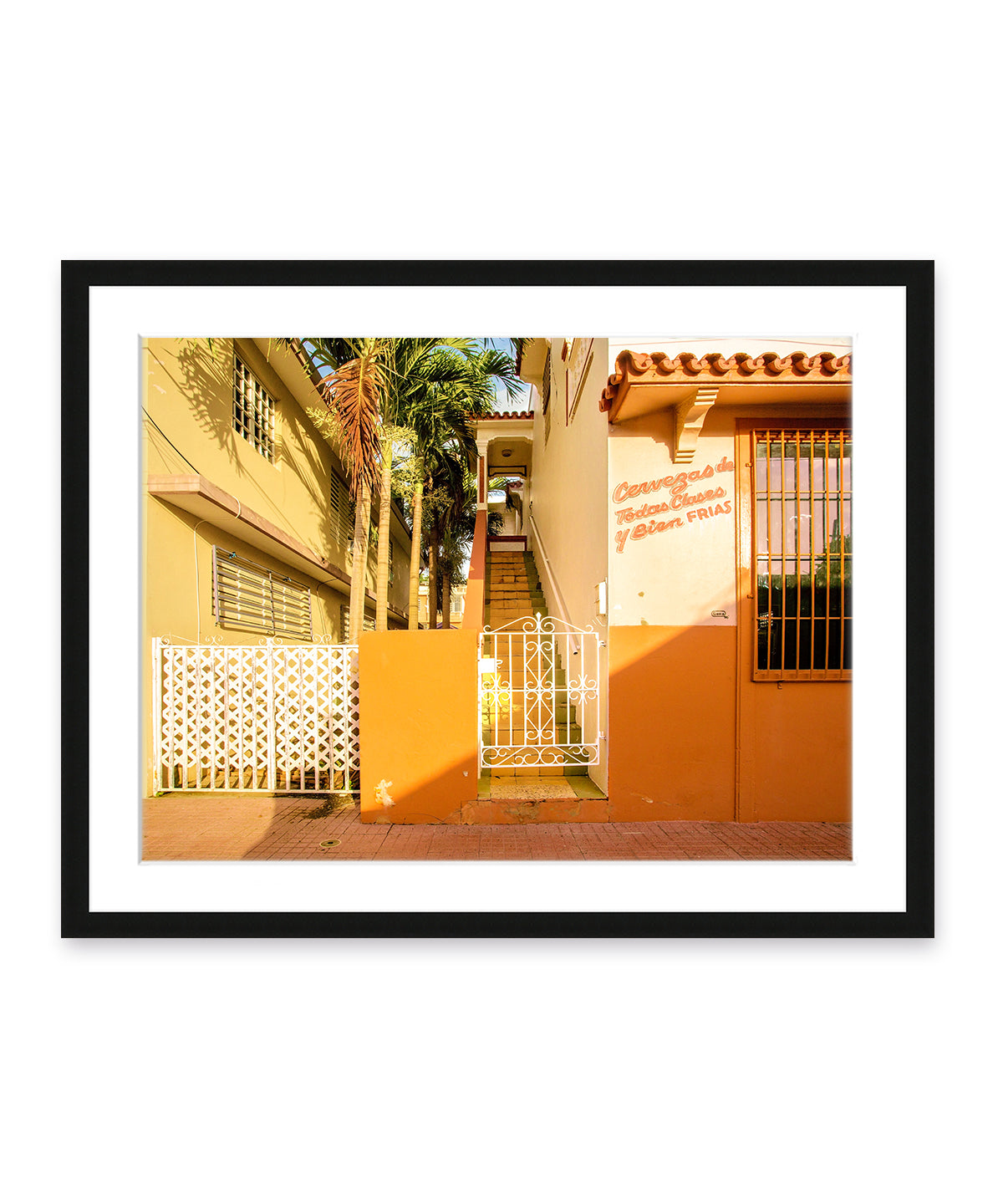 Colorful architecture photography featuring orange buildings in Rincon, Puerto Rico, black wood frame