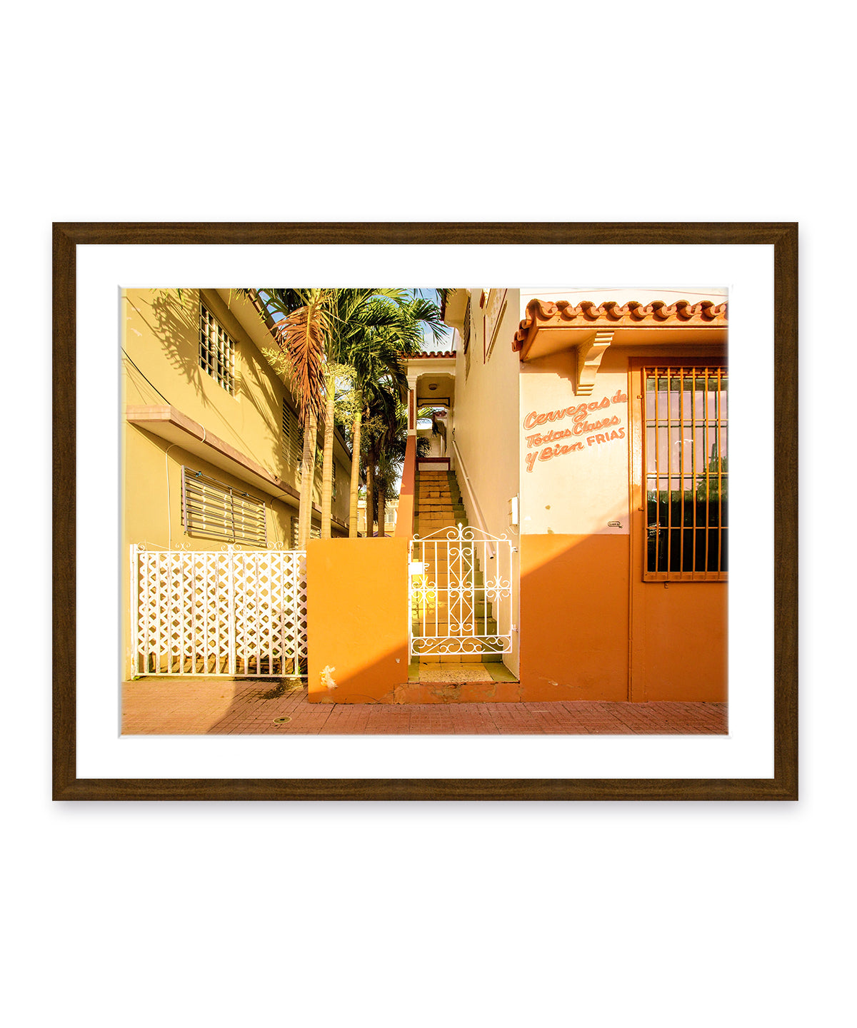 Colorful architecture photography featuring orange buildings in Rincon, Puerto Rico, dark wood frame