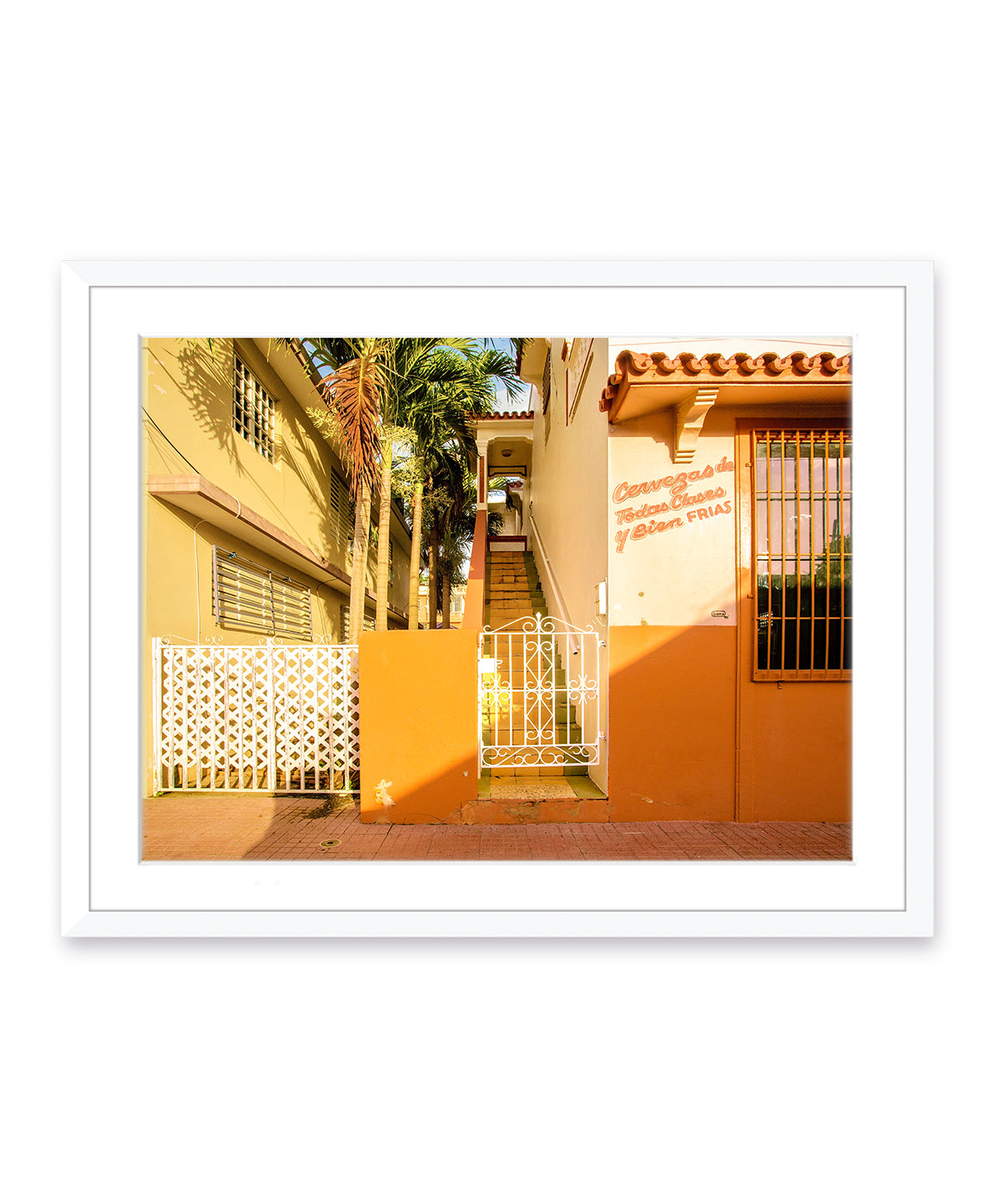 Colorful architecture photography featuring orange buildings in Rincon, Puerto Rico, white wood frame