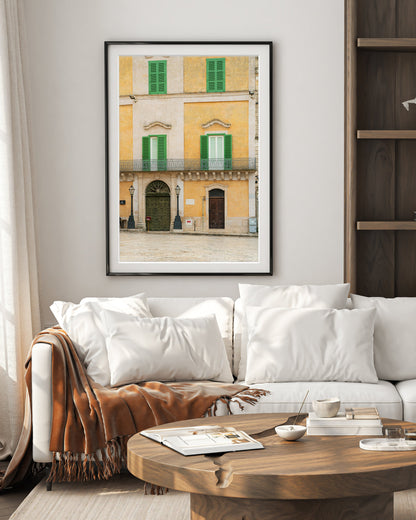 old world neutral decor with framed wall art featuring italy photograph with historic buildings filled with texture and neutral hues.
