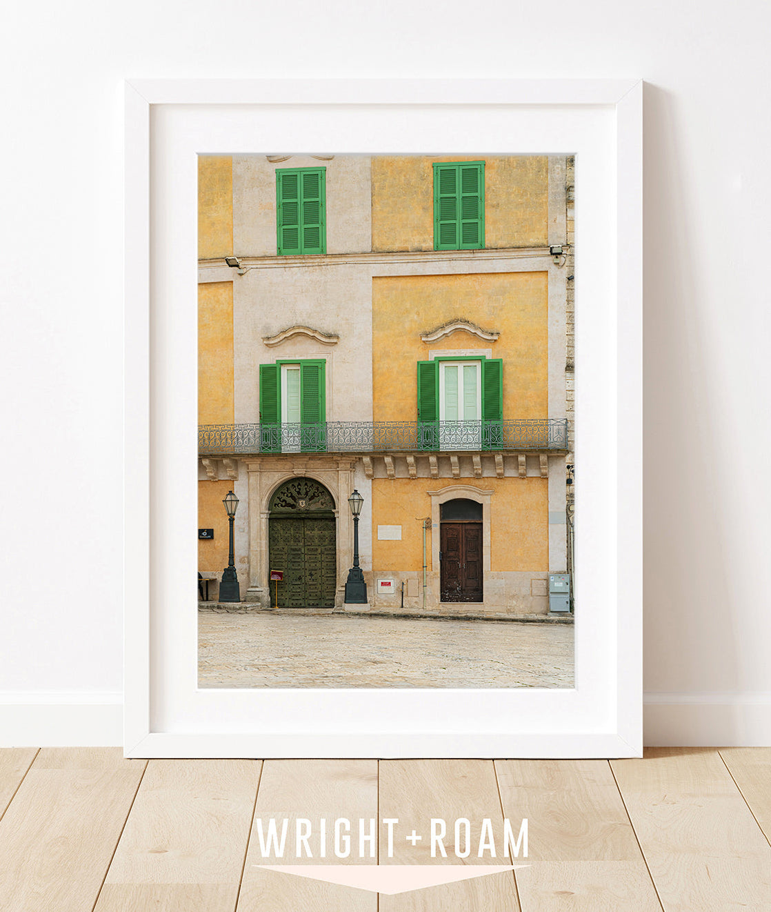 framed wall art featuring matera italy facade with texture beige, yellow, and green details.