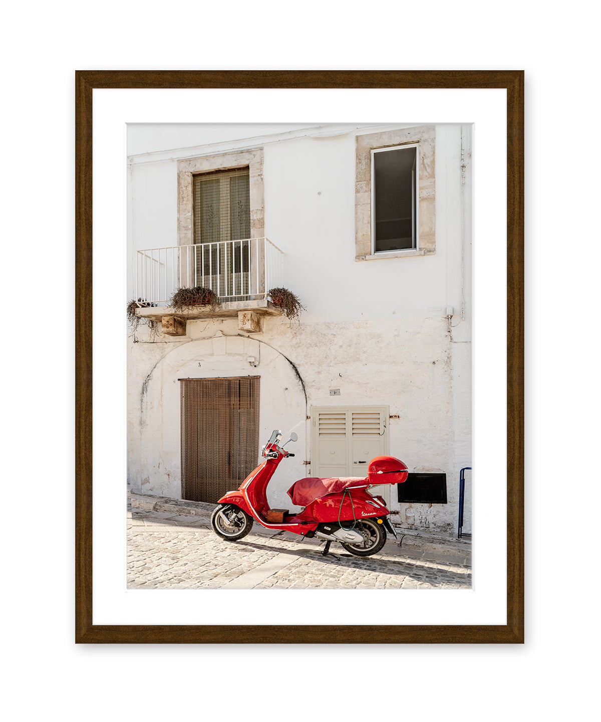 italy wall art in dark wood frame featuring white textured building accented by red moped.
