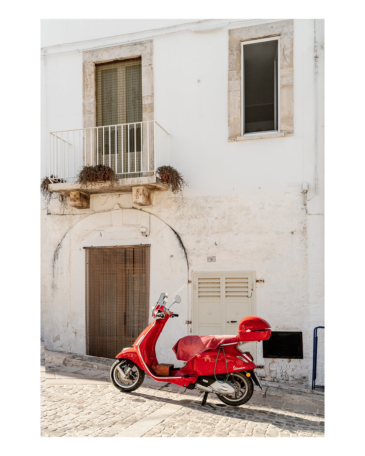 fine art italy photograph featuring white textured building accented by red moped.