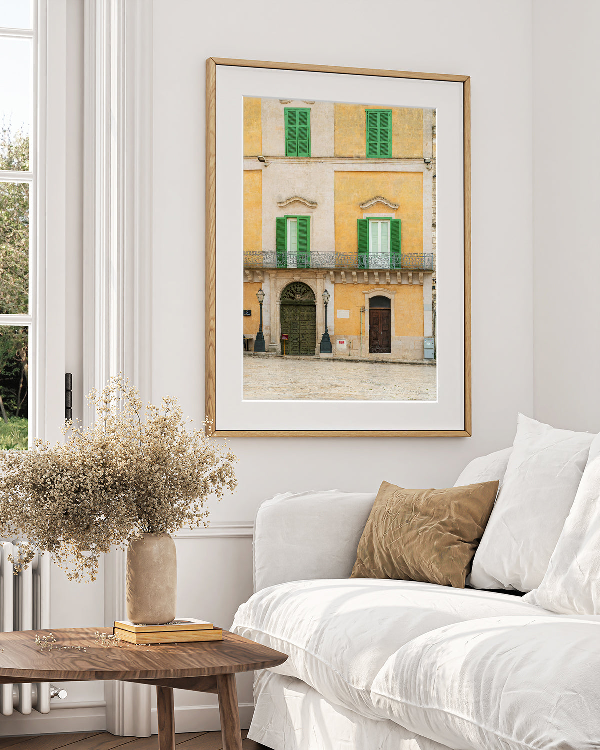 Italy photograph with historic buildings filled with texturein a neutral european inspired living room.