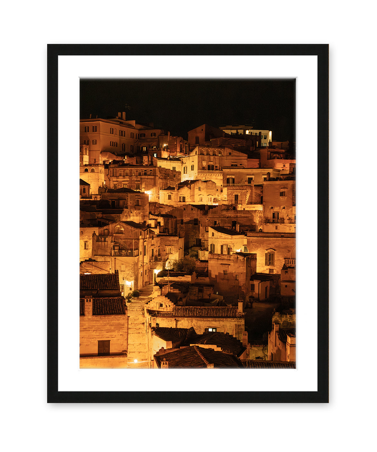 black wood frame fine art photograph of Historic city of Matera, Italy at night with glowing amber lights