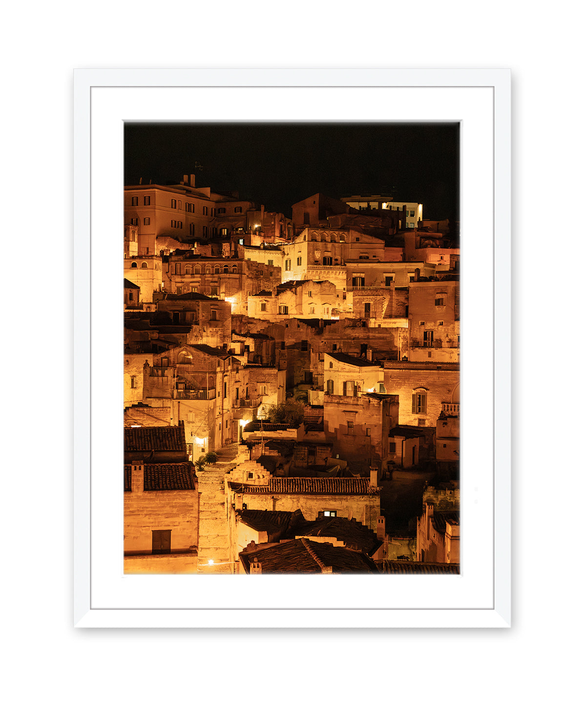white wood frame italy photograph of the Historic city of Matera at night with glowing amber lights and stone architecture