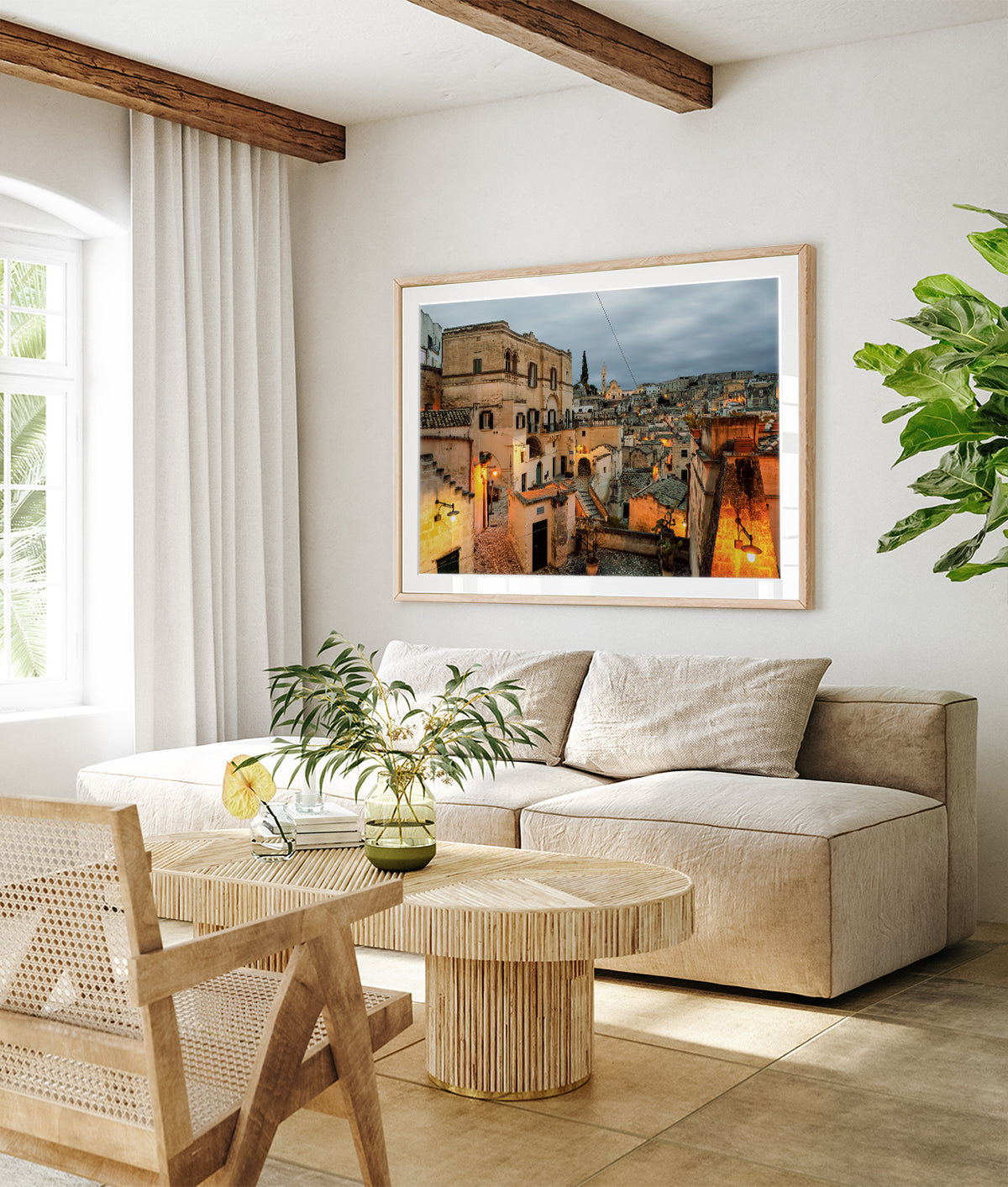 Matera, Italy twilight cityscape wall art displayed in a old world inspired neutral living room.