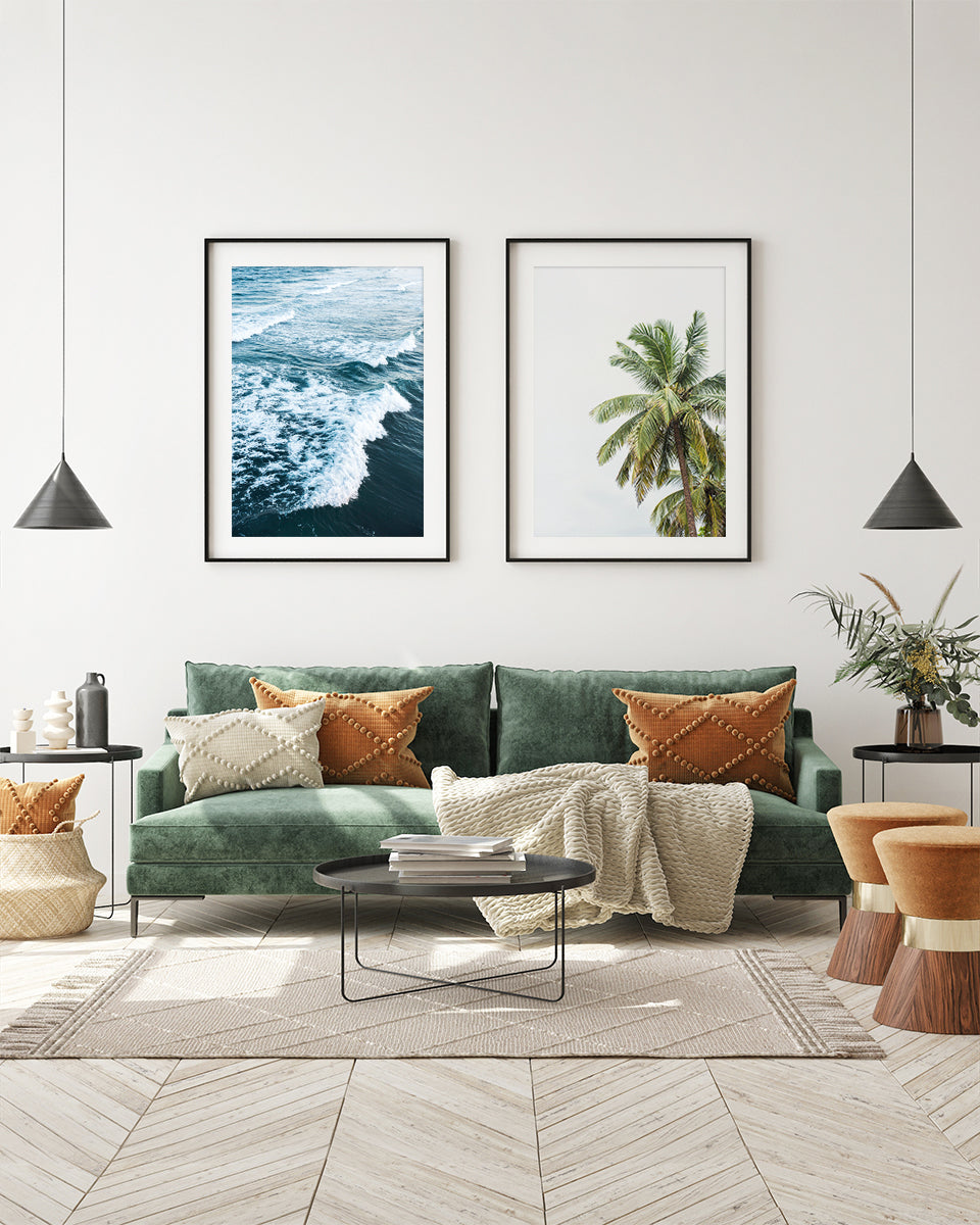 eclectic, modern living room featuring two minimalist tropical beach photographs with black frames